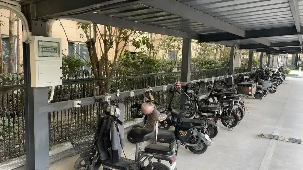 Residential e-bike charging area under a steel canopy